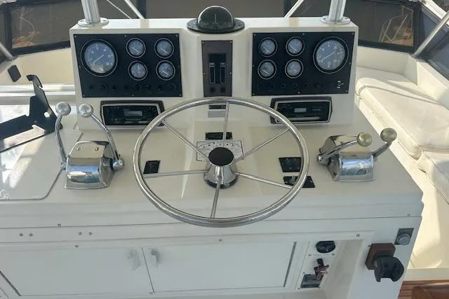 Arete Yacht Photos Pics 1988 Viking 45 Convertible helm with gauges, steering wheel, and controls.