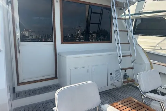 Arete Yacht Photos Pics 1988 Viking 45 Convertible yacht deck with seating and ladder.