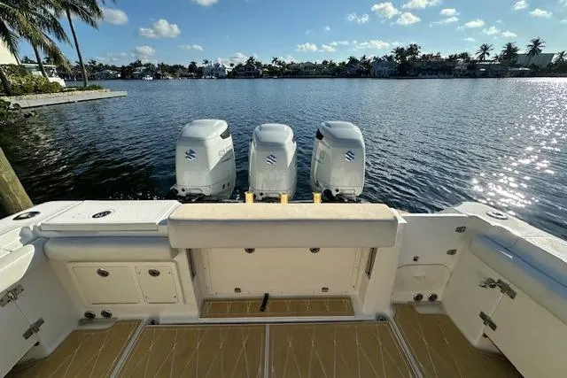  Yacht Photos Pics 2007 Hydra-Sports Vector 3300 CC boat with triple Suzuki outboard engines on a sunny waterfront.