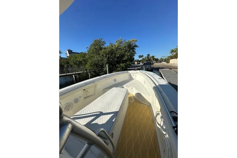  Yacht Photos Pics 2007 Hydra-Sports Vector 3300 CC boat docked near lush greenery and clear blue sky.