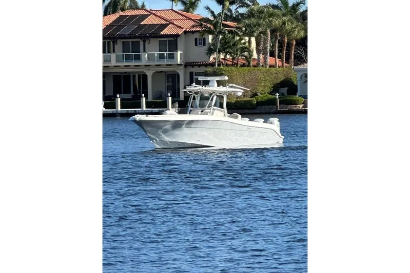  Yacht Photos Pics 2007 Hydra-Sports Vector 3300 CC boat on water near waterfront home.