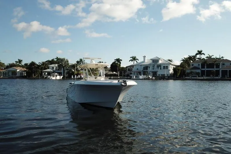  Yacht Photos Pics 2007 Hydra-Sports Vector 3300 CC boat on calm water near waterfront homes.