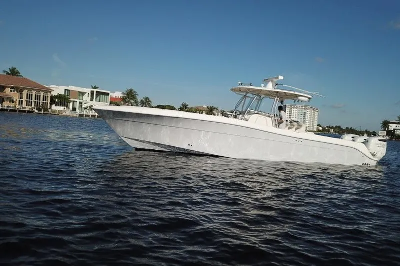  Yacht Photos Pics 2007 Hydra-Sports Vector 3300 CC boat cruising on calm waters near luxury homes.