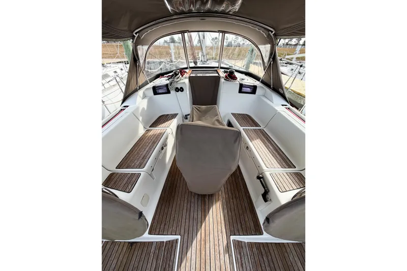 Take Five Yacht Photos Pics Interior view of 2013 Jeanneau Sun Odyssey 409 sailboat cockpit with wooden flooring.