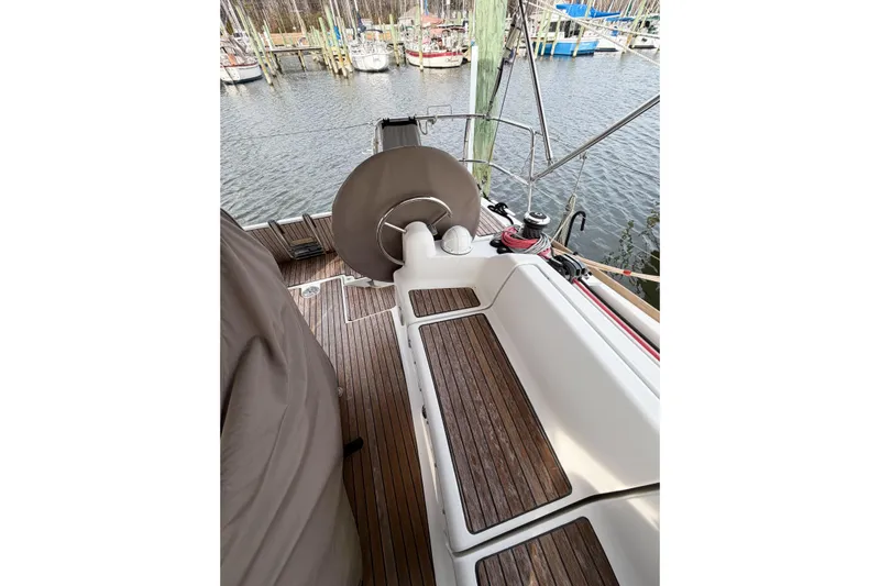 Take Five Yacht Photos Pics Cockpit of 2013 Jeanneau Sun Odyssey 409 sailboat with wooden deck and steering wheel.