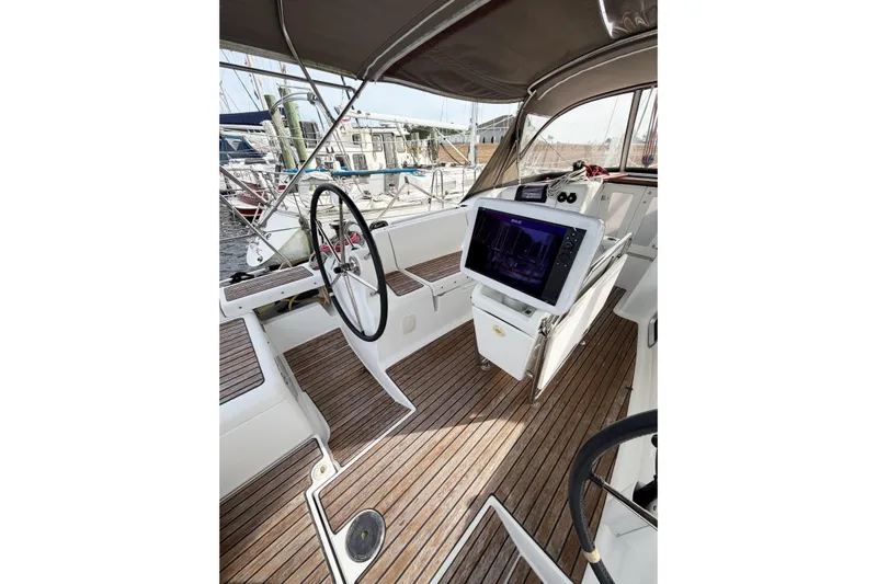 Take Five Yacht Photos Pics Cockpit of 2013 Jeanneau Sun Odyssey 409 sailboat with wooden flooring and navigation equipment.