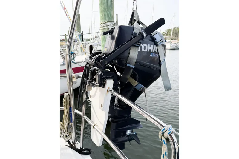 Take Five Yacht Photos Pics Outboard motor mounted on Jeanneau Sun Odyssey 409 sailboat, 2013 model, in marina setting.