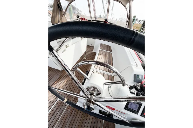 Take Five Yacht Photos Pics Steering wheel of 2013 Jeanneau Sun Odyssey 409 sailboat with wooden deck.