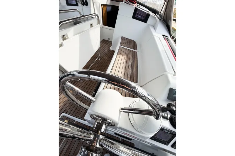 Take Five Yacht Photos Pics Cockpit of 2013 Jeanneau Sun Odyssey 409 sailboat with wooden flooring and steering wheel.