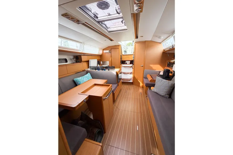 Take Five Yacht Photos Pics Interior of 2013 Jeanneau Sun Odyssey 409 sailboat, featuring modern wood finish and seating.
