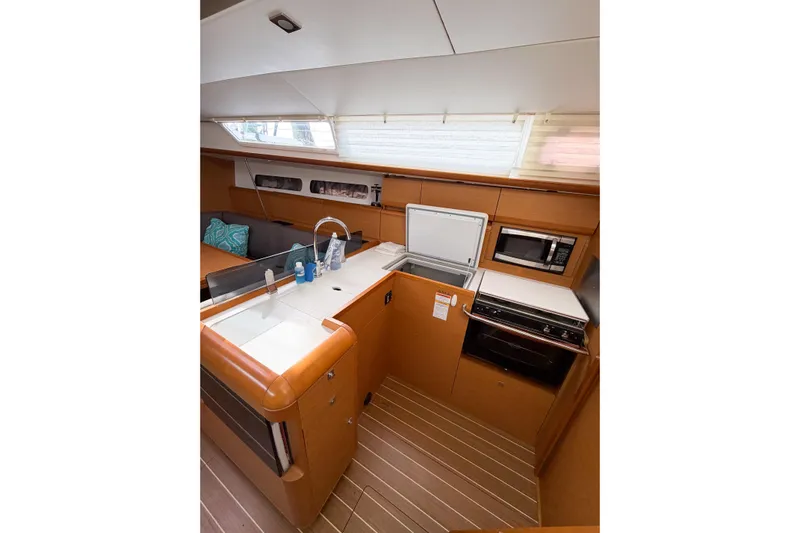 Take Five Yacht Photos Pics Interior of 2013 Jeanneau Sun Odyssey 409 yacht, featuring a modern kitchen galley.