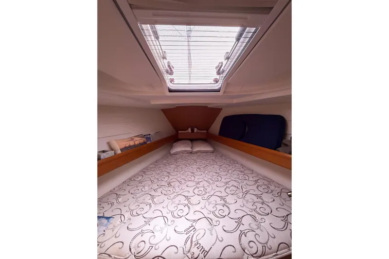 Take Five Yacht Photos Pics Cozy cabin interior of 2013 Jeanneau Sun Odyssey 409 sailboat with skylight and patterned bedding.