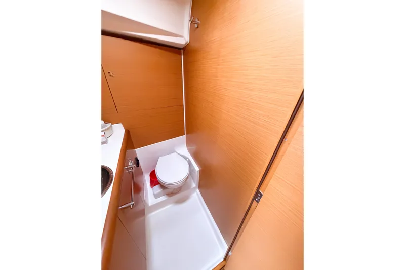 Take Five Yacht Photos Pics 2013 Jeanneau Sun Odyssey 409 yacht bathroom with wooden paneling and compact toilet.