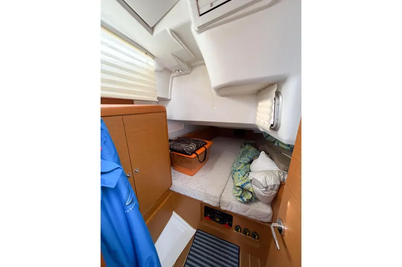 Take Five Yacht Photos Pics Cozy cabin interior of 2013 Jeanneau Sun Odyssey 409 sailboat with bedding and storage.