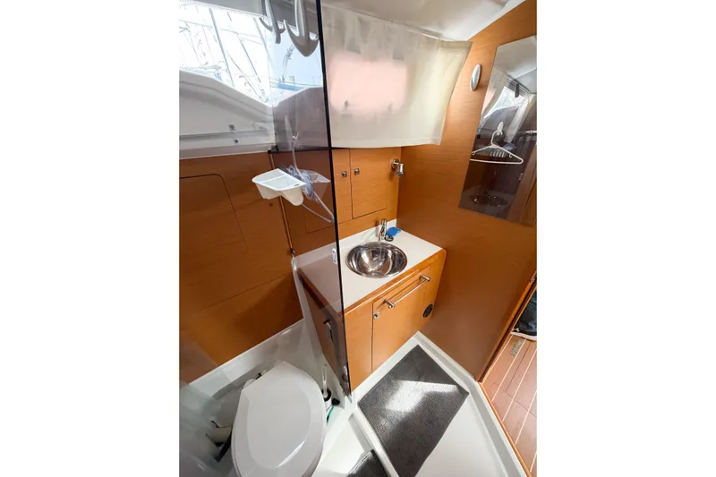 Take Five Yacht Photos Pics 2013 Jeanneau Sun Odyssey 409 bathroom with modern fixtures and wooden cabinetry.