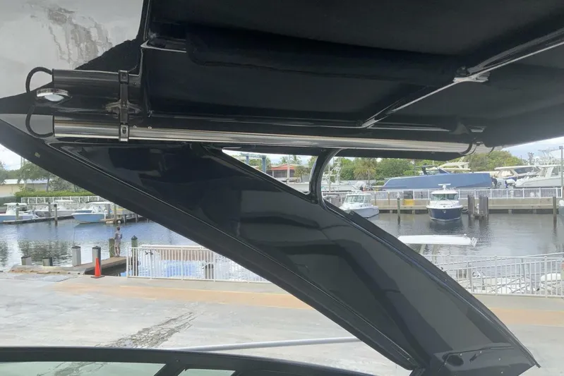  Yacht Photos Pics 2015 Cruisers Sport Series 328 BR boat canopy with marina view in the background.