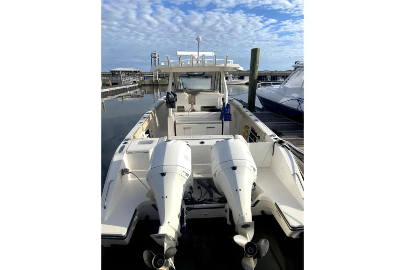  Yacht Photos Pics 2018 Pursuit S 328 Sport boat with dual outboard engines docked at marina.