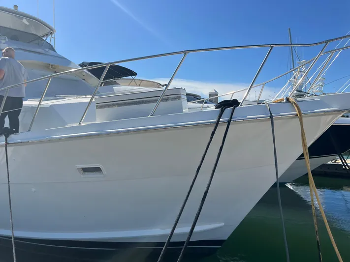 Final Kiwi Yacht Photos Pics 1995 Hatteras 74 Cockpit Motor Yacht docked in marina, side view.