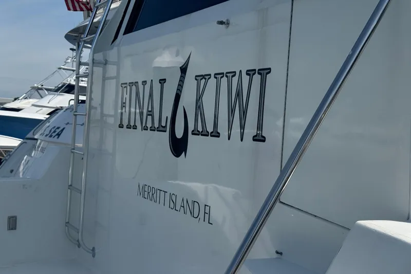 Final Kiwi Yacht Photos Pics 1995 Hatteras 74 Cockpit Motor Yacht, "Final Kiwi," Merritt Island, FL, docked with ladder.