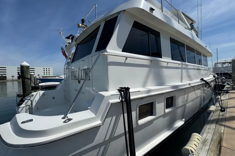 Final Kiwi Yacht Photos Pics 1995 Hatteras 74 Cockpit Motor Yacht docked at marina under clear blue sky.