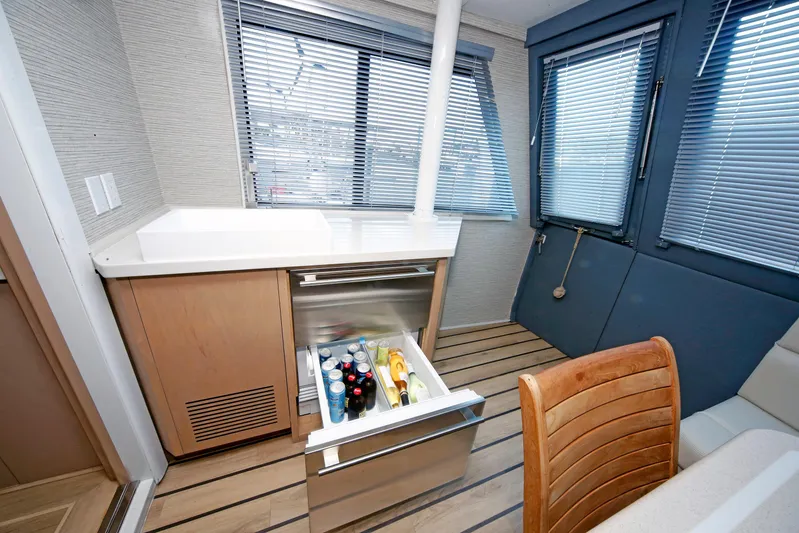 Final Kiwi Yacht Photos Pics Interior of 1995 Hatteras 74 Cockpit Motor Yacht with open fridge drawer.