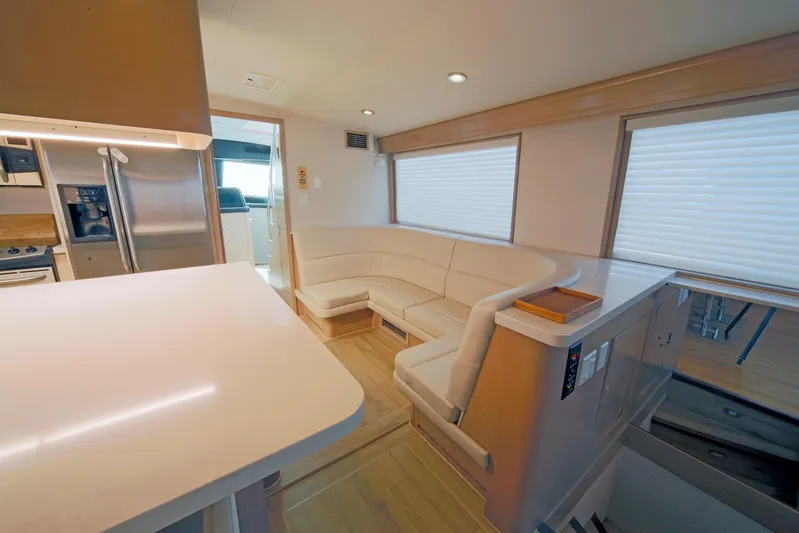 Final Kiwi Yacht Photos Pics Interior of 1995 Hatteras 74 Cockpit Motor Yacht with modern kitchen and seating area.