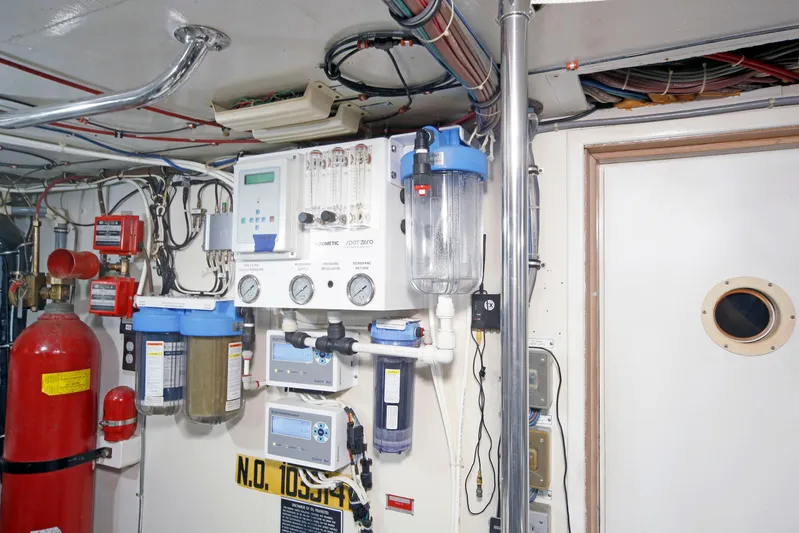 Final Kiwi Yacht Photos Pics Engine room of 1995 Hatteras 74 Cockpit Motor Yacht with control panels and equipment.