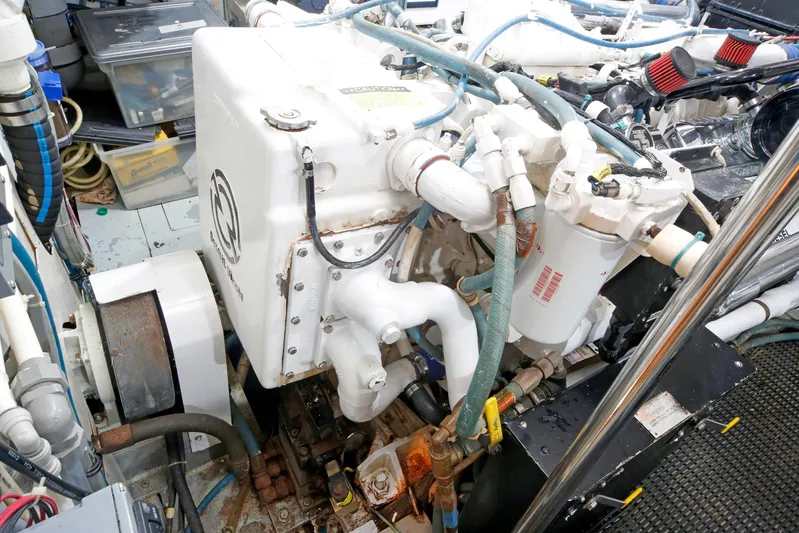 Final Kiwi Yacht Photos Pics Engine room of 1995 Hatteras 74 Cockpit Motor Yacht with visible machinery and components.