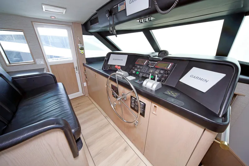 Final Kiwi Yacht Photos Pics 1995 Hatteras 74 Cockpit Motor Yacht helm with Garmin navigation system and leather seating.