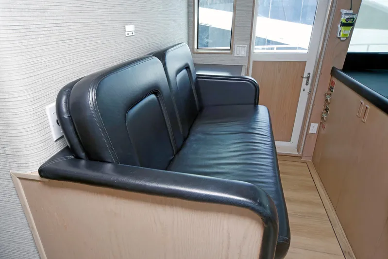 Final Kiwi Yacht Photos Pics Black leather seating in 1995 Hatteras 74 Cockpit Motor Yacht interior.