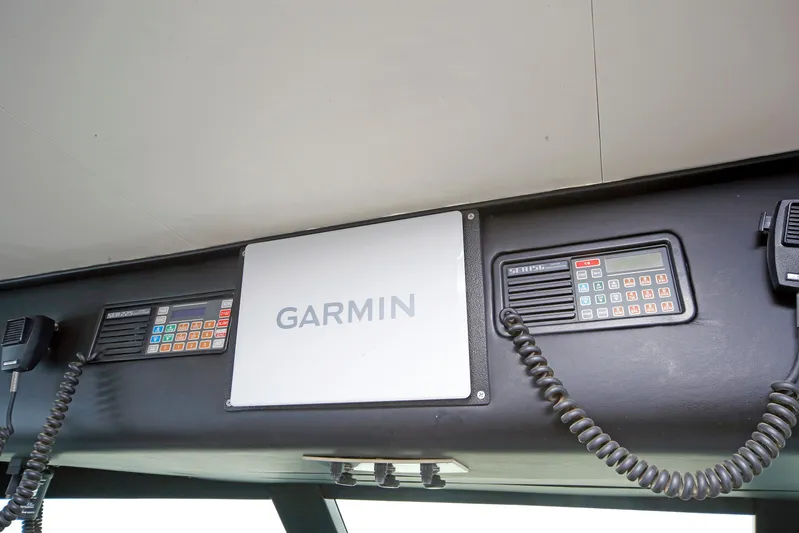 Final Kiwi Yacht Photos Pics Control panel of 1995 Hatteras 74 Cockpit Motor Yacht with Garmin navigation system.