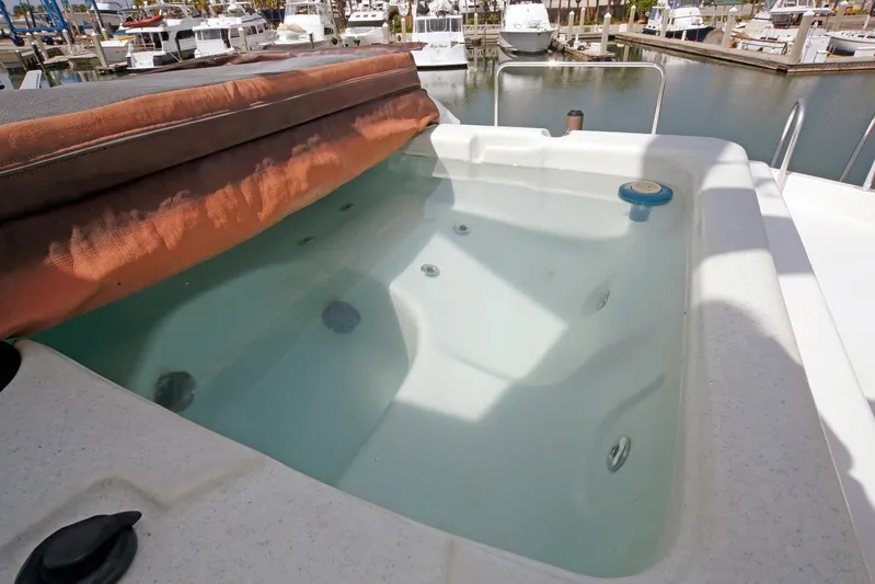 Final Kiwi Yacht Photos Pics Jacuzzi on 1995 Hatteras 74 Cockpit Motor Yacht, docked at marina.