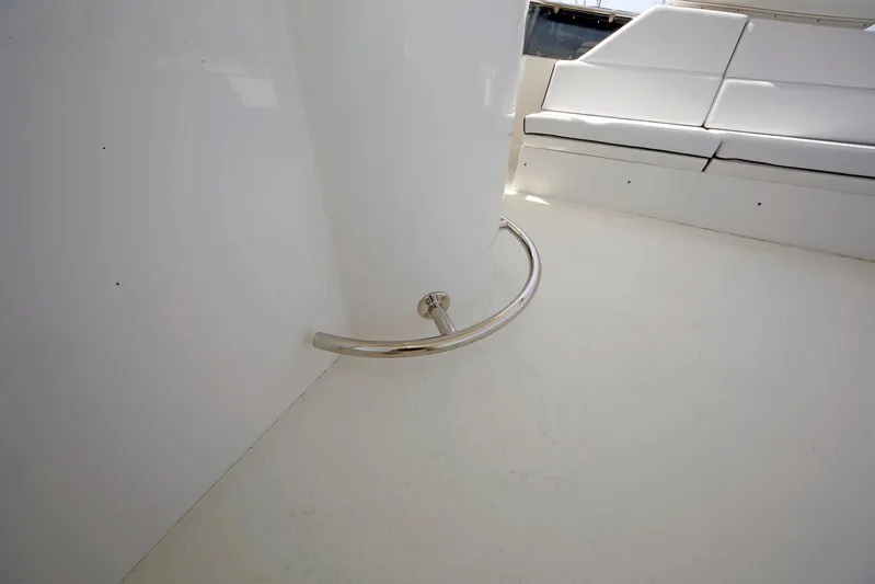 Final Kiwi Yacht Photos Pics Interior of 1995 Hatteras 74 Cockpit Motor Yacht with white seating and metal railing.