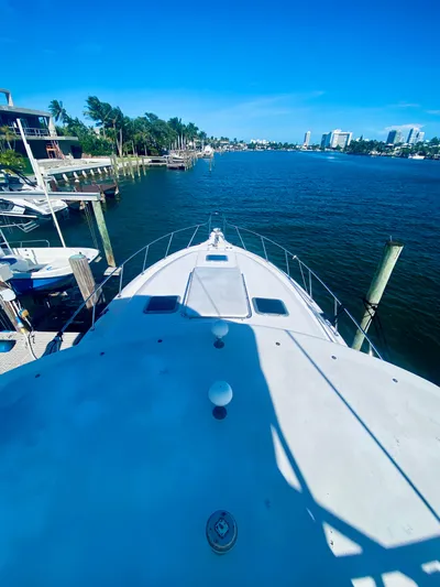  Yacht Photos Pics Tiara Yachts 1999 43 Open on a scenic waterfront, clear blue sky.