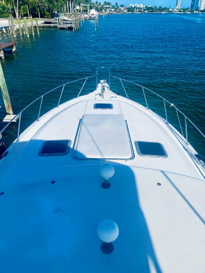  Yacht Photos Pics 1999 Tiara Yachts 43 Open on calm water, docked at a marina.