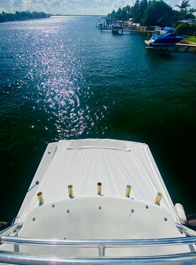  Yacht Photos Pics 1999 Tiara Yachts 43 Open on serene water with scenic shoreline view.