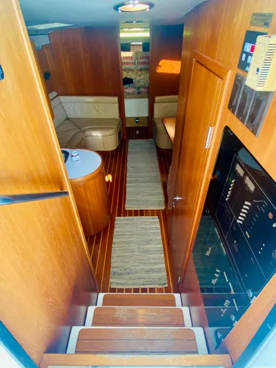  Yacht Photos Pics Interior of 1999 Tiara Yachts 43 Open, featuring wood paneling and cozy seating.
