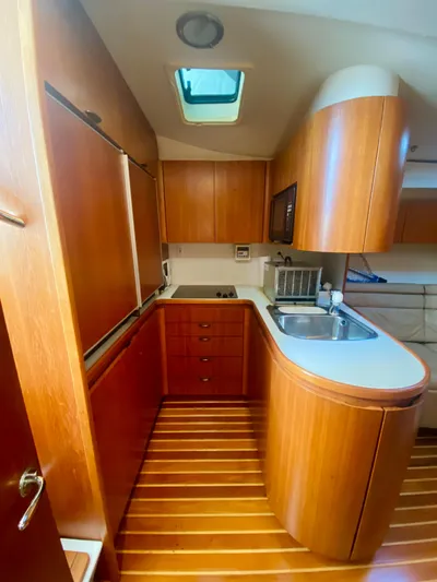  Yacht Photos Pics Luxurious 1999 Tiara Yachts 43 Open kitchen with wood cabinetry and modern amenities.