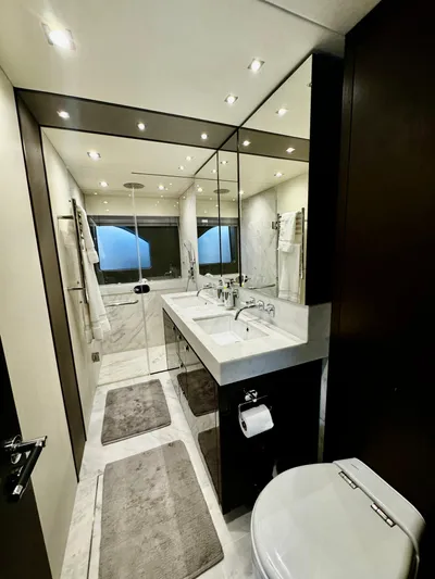 Journey Yacht Photos Pics Luxurious bathroom in 2019 Sunseeker 76 Yacht with modern fixtures and elegant design.