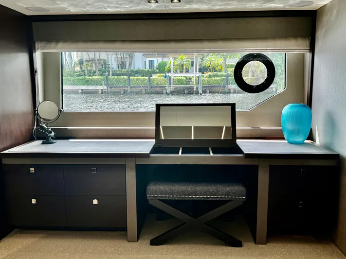 Journey Yacht Photos Pics Luxurious interior of 2019 Sunseeker 76 Yacht with desk, window view, and elegant decor.