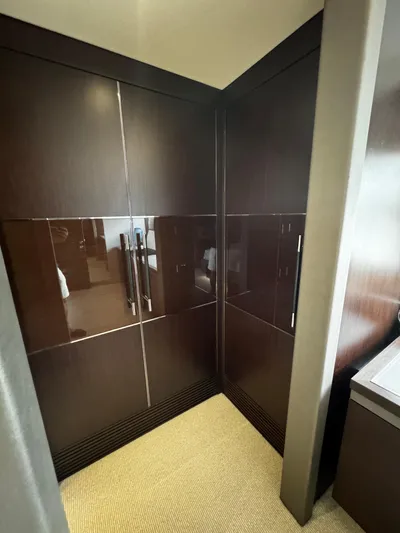 Journey Yacht Photos Pics Luxurious interior of a 2019 Sunseeker 76 Yacht with sleek wooden cabinetry.