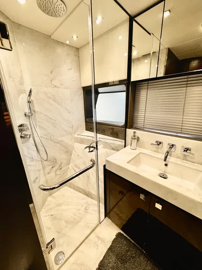 Journey Yacht Photos Pics Luxurious bathroom in 2019 Sunseeker 76 Yacht with marble shower and modern fixtures.