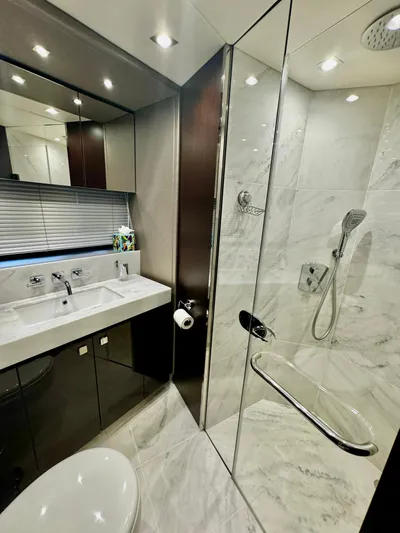Journey Yacht Photos Pics Luxurious bathroom in 2019 Sunseeker 76 Yacht with marble shower and modern fixtures.