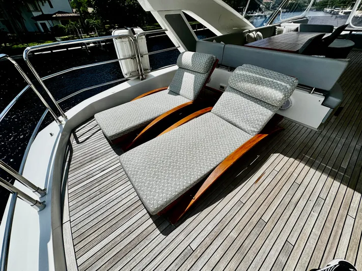 Journey Yacht Photos Pics Sunseeker 76 Yacht 2019 deck with elegant sun loungers and wooden flooring.