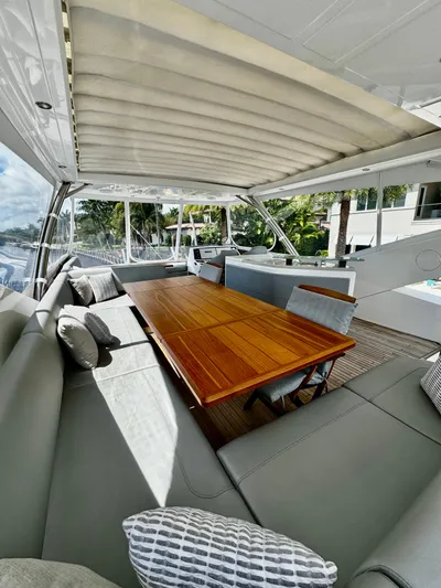 Journey Yacht Photos Pics Luxurious 2019 Sunseeker 76 Yacht interior with elegant seating and wooden dining table.