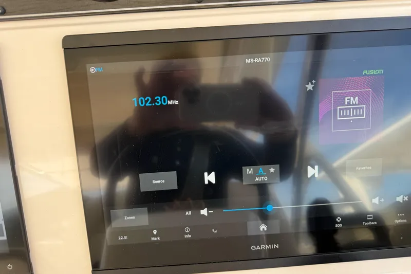 335-514 Brokerage Ron Yacht Photos Pics Garmin display on 2023 Grady-White Freedom 335 showing FM radio at 102.30 MHz.