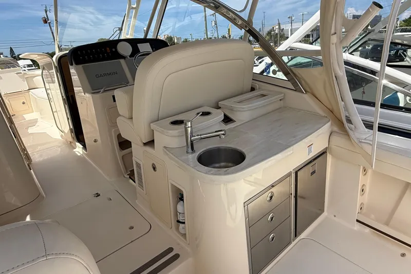 335-514 Brokerage Ron Yacht Photos Pics 2023 Grady-White Freedom 335 boat interior with sink, storage, and Garmin navigation system.