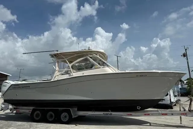 335-514 Brokerage Ron Yacht Photos Pics 2023 Grady-White Freedom 335 boat on trailer under cloudy sky.