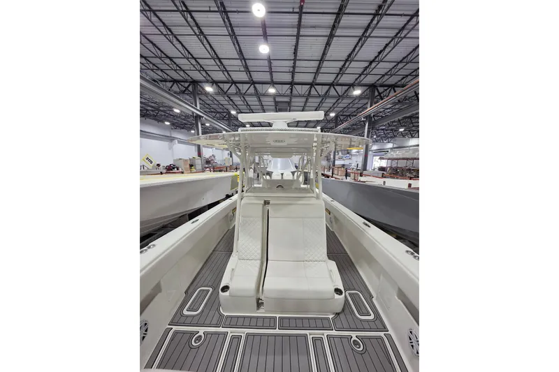 Seavee Yacht Photos Pics 2017 SeaVee 390Z boat interior with seating, in a spacious warehouse setting.