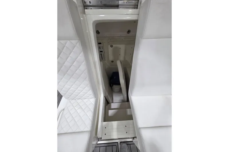 Seavee Yacht Photos Pics 2017 SeaVee 390Z interior with white quilted seating and storage compartment.